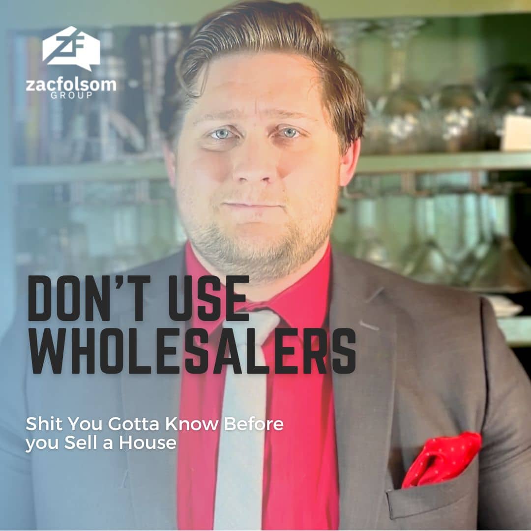 A picture of Zac Folsom wearing a grey suit with a red pocket square, standing confidently and holding a "Don't Use Wholesalers" sign.