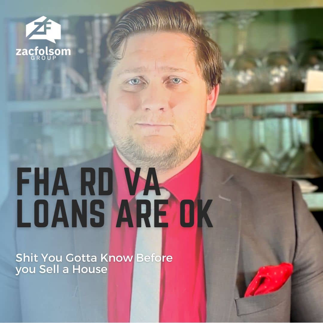 Picture of Zac Folsom standing in front of a wall with the words "FHA RD VA loans are ok" written in big letters in front him.