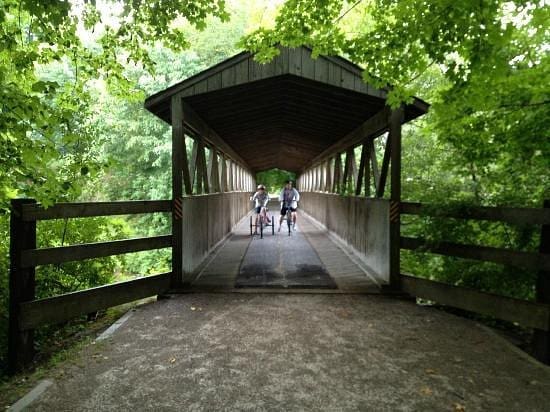Two people riding bikes down the Kal Haven Trail in Kalamazoo, MI.