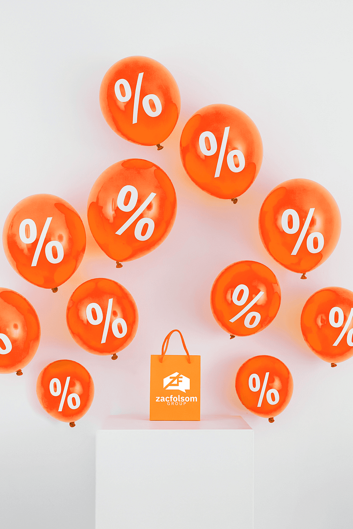 A bag with the Zac Folsom Group logo surrounded by balloons with percentages on them.